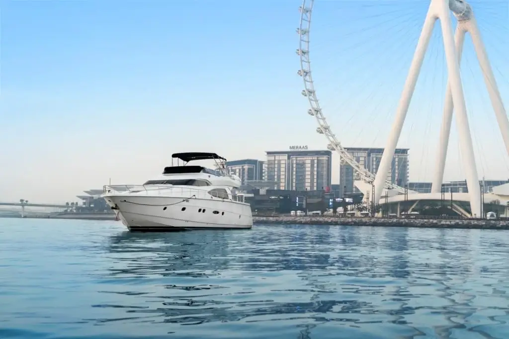 Yacht cruising near Ain Dubai observation wheel at Bluewaters Island