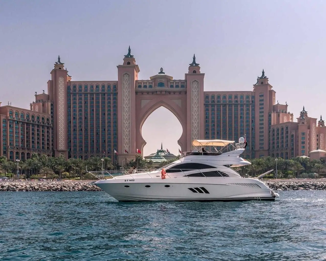 Private yacht cruising in front of the Atlantis hotel on Palm Jumeirah in Dubai