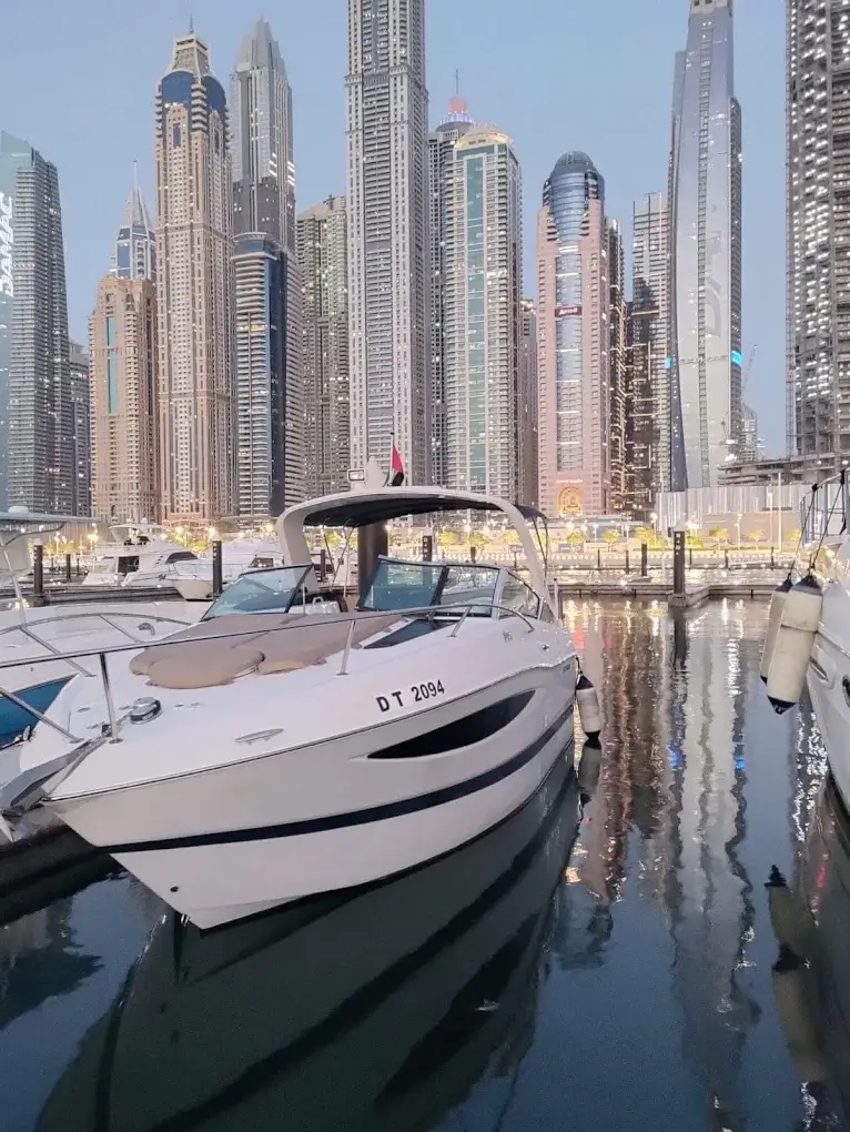 Luxury yacht cruising the Dubai coastline at dusk